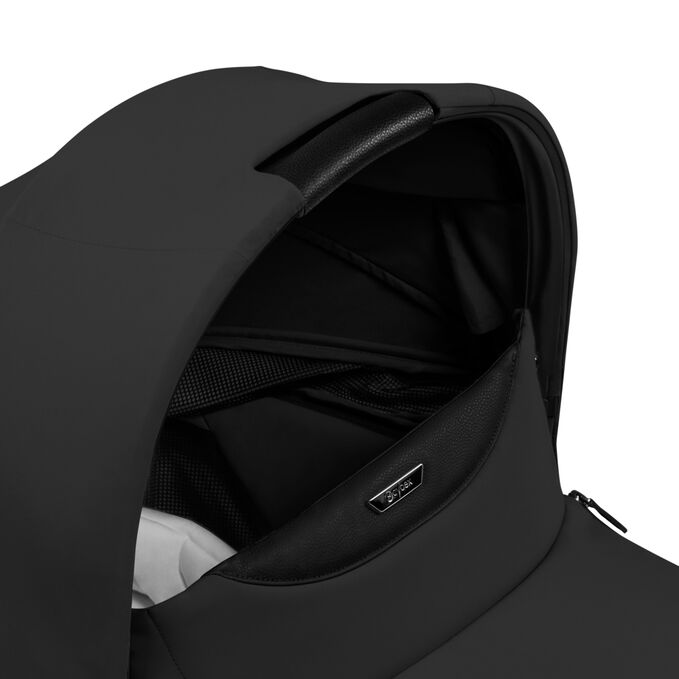 An image of the CYBEX Platinum Mios/Coya Fold Lux Carry Cot - Style Collection Stroller, highlighting the Canopy Carry Handle feature.