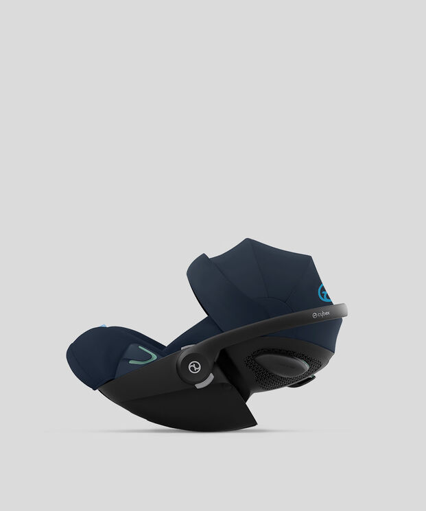 A dark blue Cybex car seat in side view against a grey background.