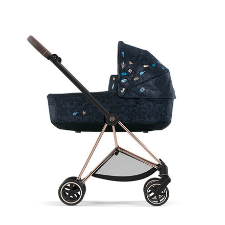 Dark blue pram with colorful embroidery, side view.