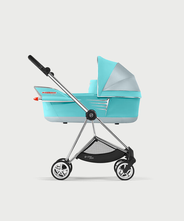 Turquoise and silver pram with wing design by Jeremy Scott Wings, side view.