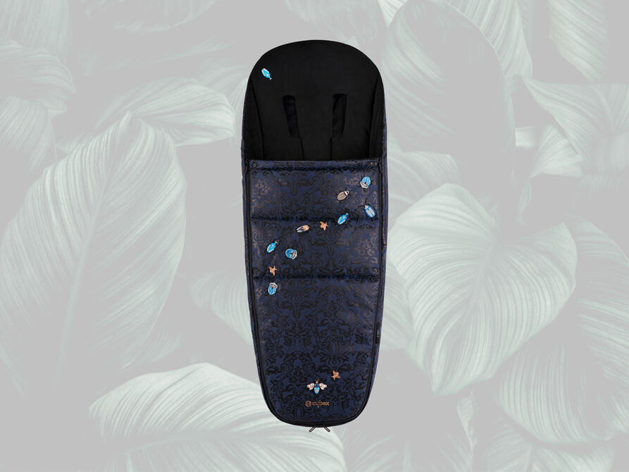 A dark blue pram footmuff with a floral pattern and colourful butterfly embroidery on a grey background.