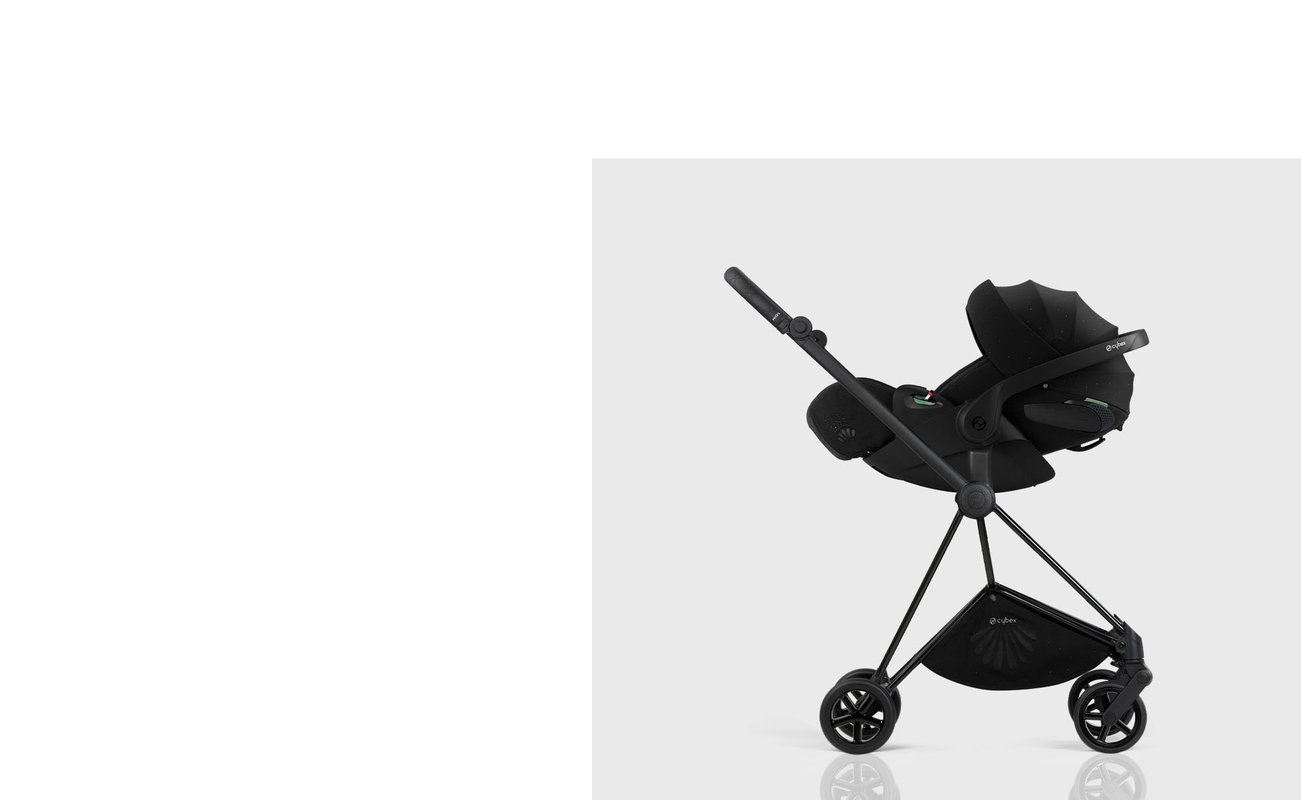 La Parisienne stroller in black with a modern design on a grey background.