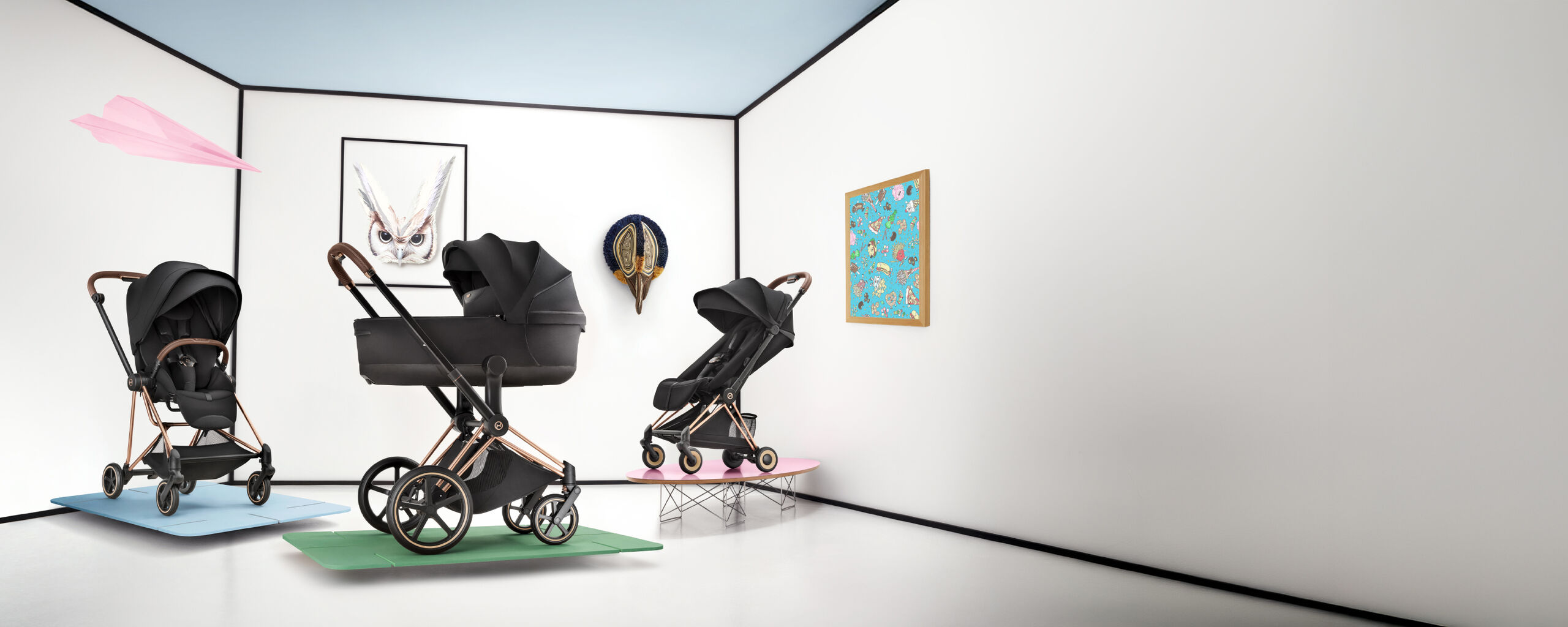 Three CYBEX Platinum strollers. On the left and right are ones with a seat pack attached, and in the middle, one with a cot.