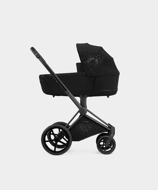 La Parisienne black pram, side view on a white background.