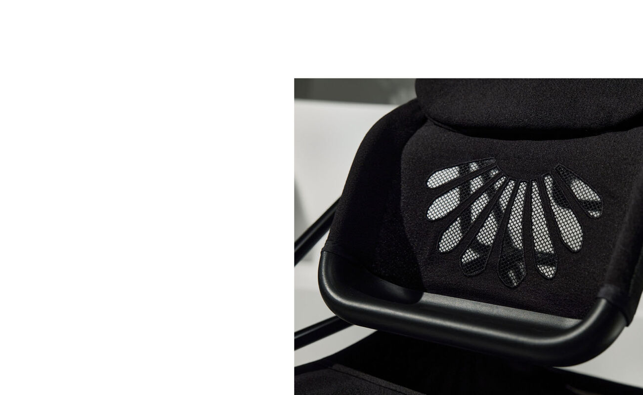 La Parisienne chair detail with black mesh design.