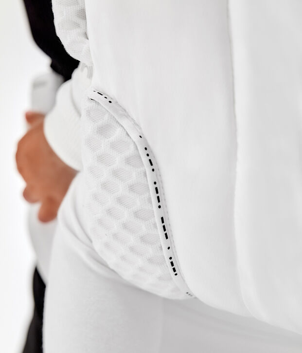 White jacket with textured fabric and black accent on the pocket.