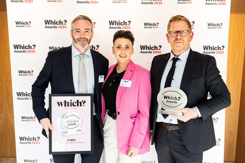Three people standing in front of a wall with the "Which? Awards 2024" logo. One person holds a framed award, while another holds a trophy.