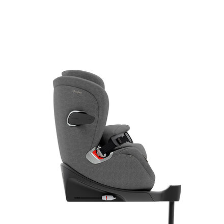 A grey Cybex child car seat in side view, mounted on a black base.