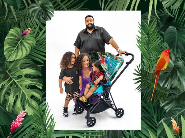 DJ Khaled with his family in a tropical look next to a Cybex pushchair with parrot design, taken in a garden by the pool