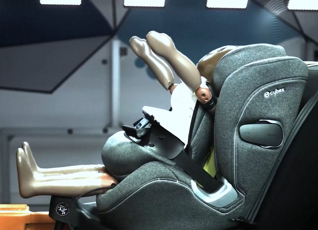 A crash test dummy in a Cybex child car seat during a safety test.