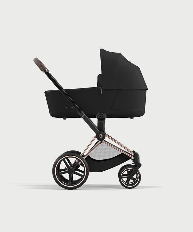 Black pram with sleek design and large wheels.