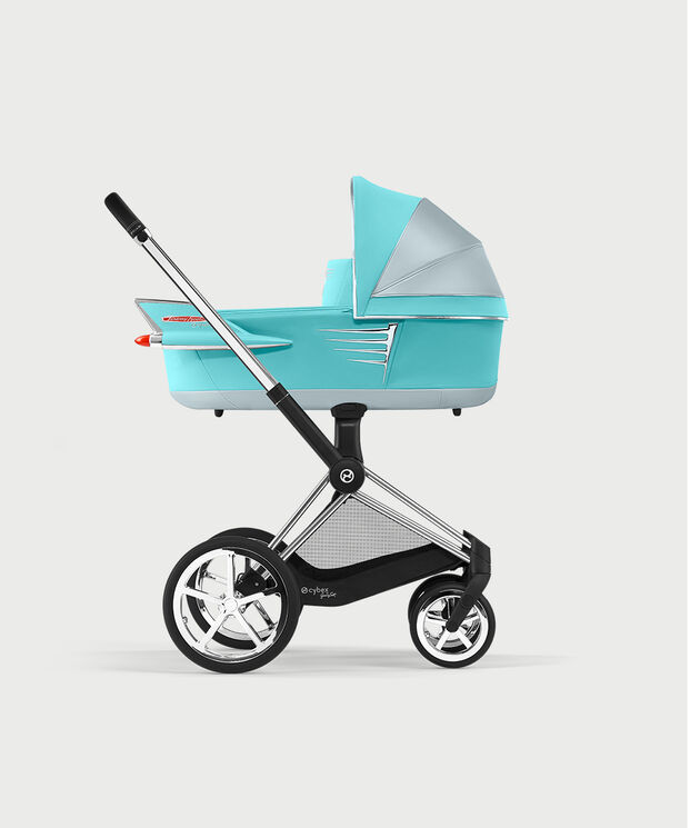 Turquoise by Jeremy Scott Wings pram with silver accents, side view.