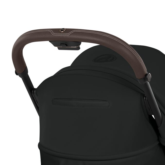 An image of the CYBEX Platinum Coya - Style Collection Buggy, highlighting the Easy-to-Reach Backrest Pocket feature.