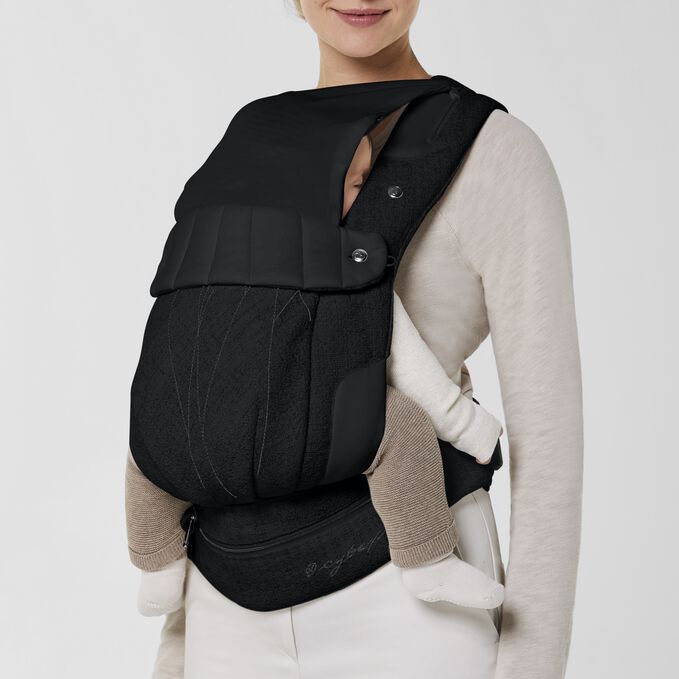An image of the CYBEX Platinum Coya Carrier Boucl&eacute; Baby Carrier, highlighting the Integrated Head Cover feature.