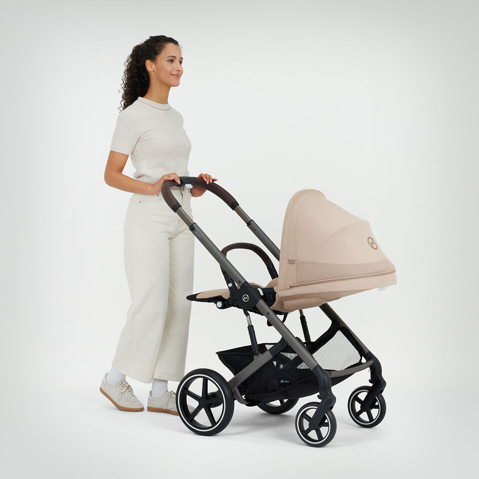 A woman pushing a Balios S Lux with a lie-flat position. 