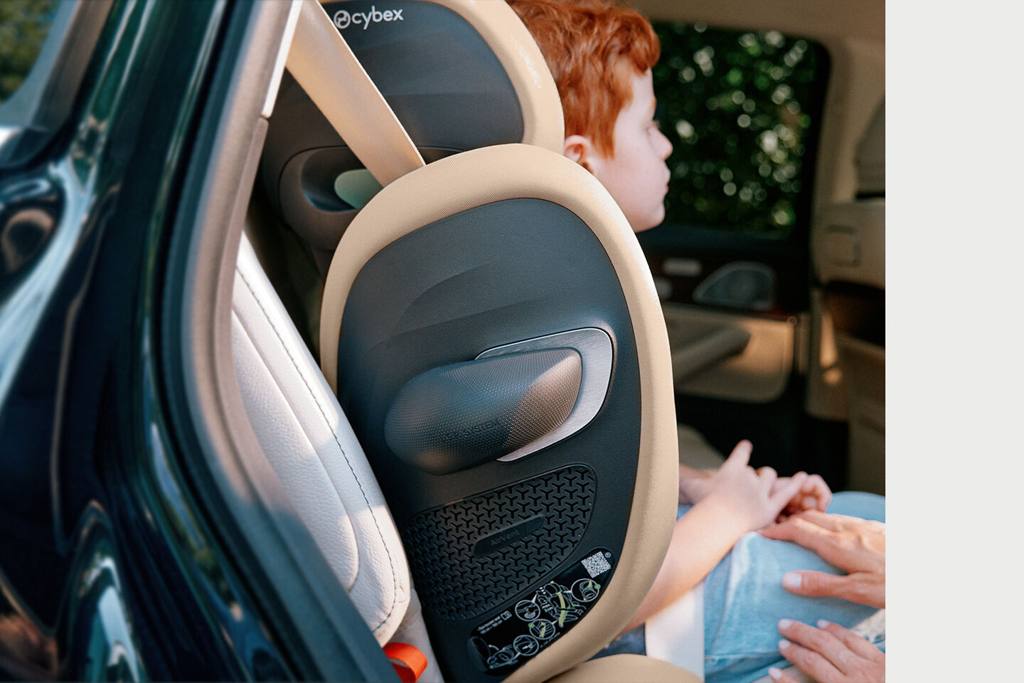 A child seated in a car on a Solution G2 travel car seat.