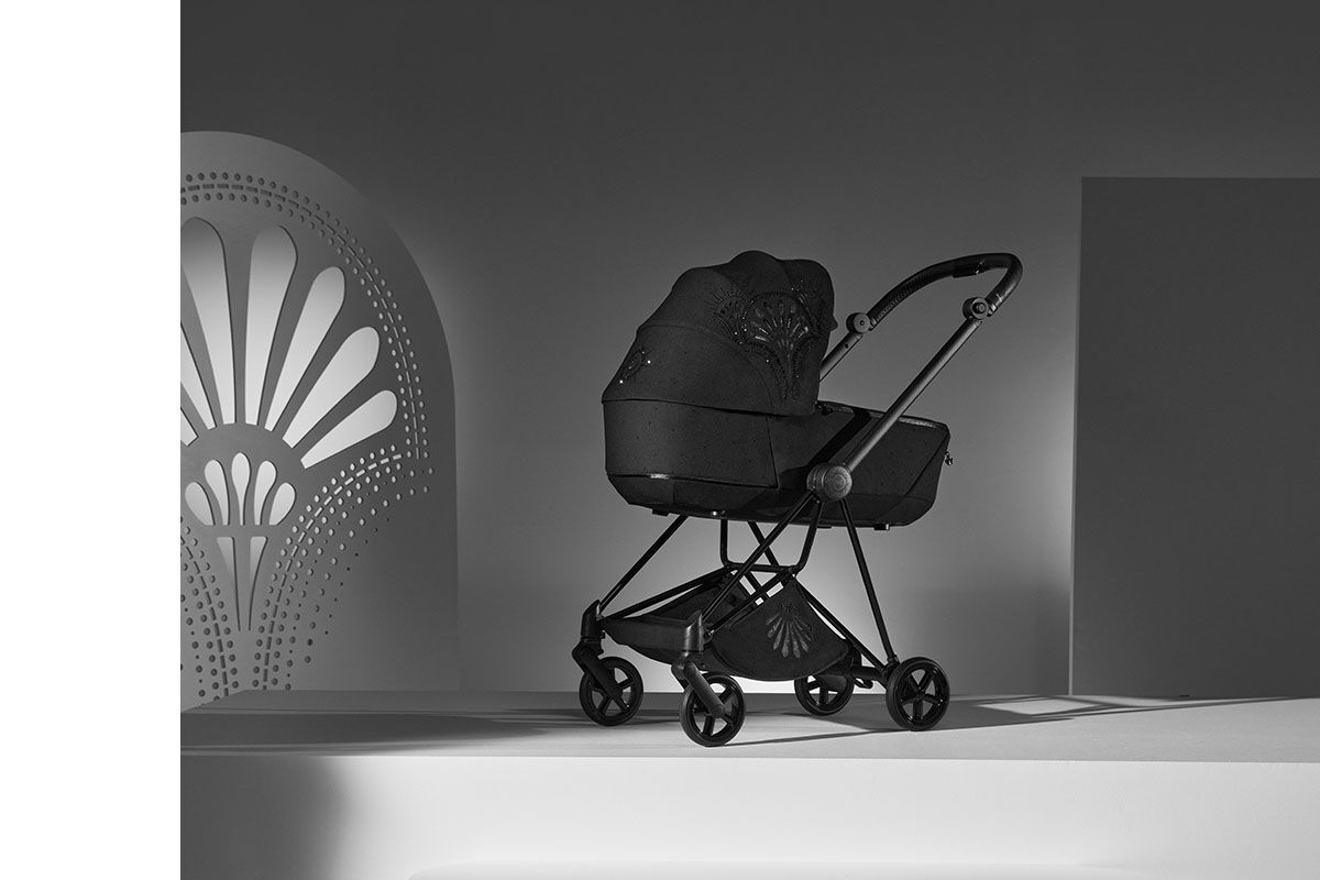 La Parisienne stroller in an elegant, modern design, showcased in a stylish, monochrome setting.