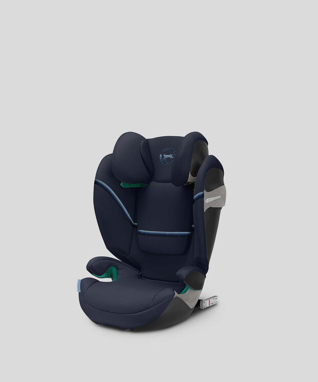 A dark blue child car seat with padded sides and headrest on a grey background.