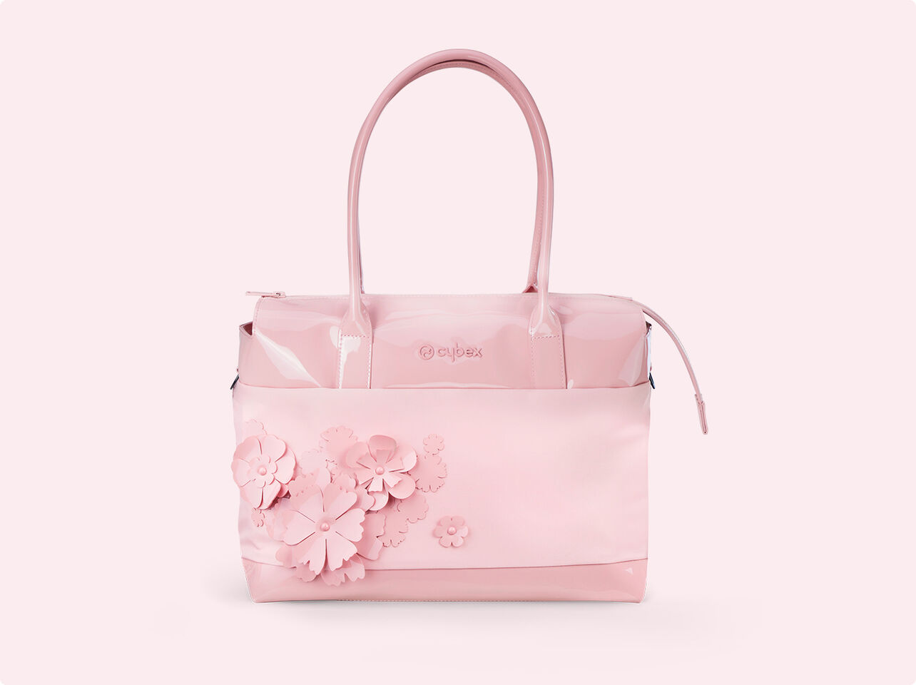 CYBEX Simply Flowers sk&ouml;tv&auml;ska i mjukt rosa med blommiga applikationer.