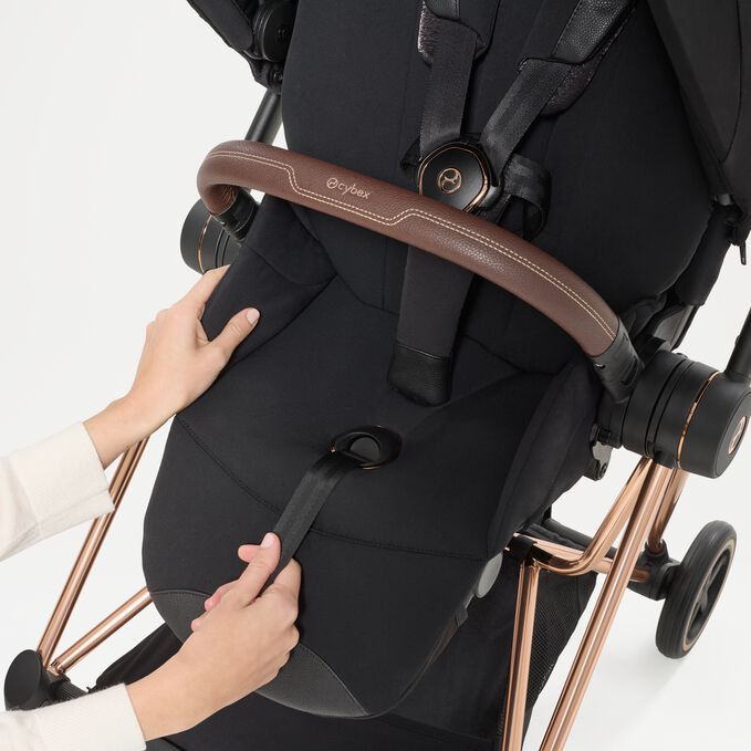 An image of the CYBEX Platinum Mios Seat Pack - Style Collection Stroller, highlighting the One-pull Harness feature.