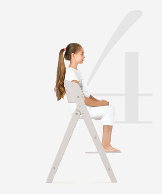 Girl sitting on a Click and Fold high chair in side view.