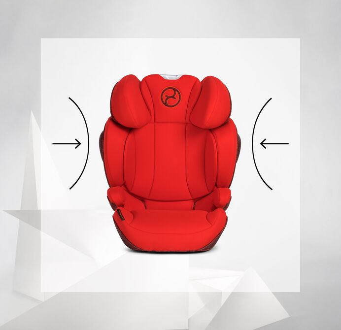 A red child car seat with side protection cushions and a logo at the top centre.