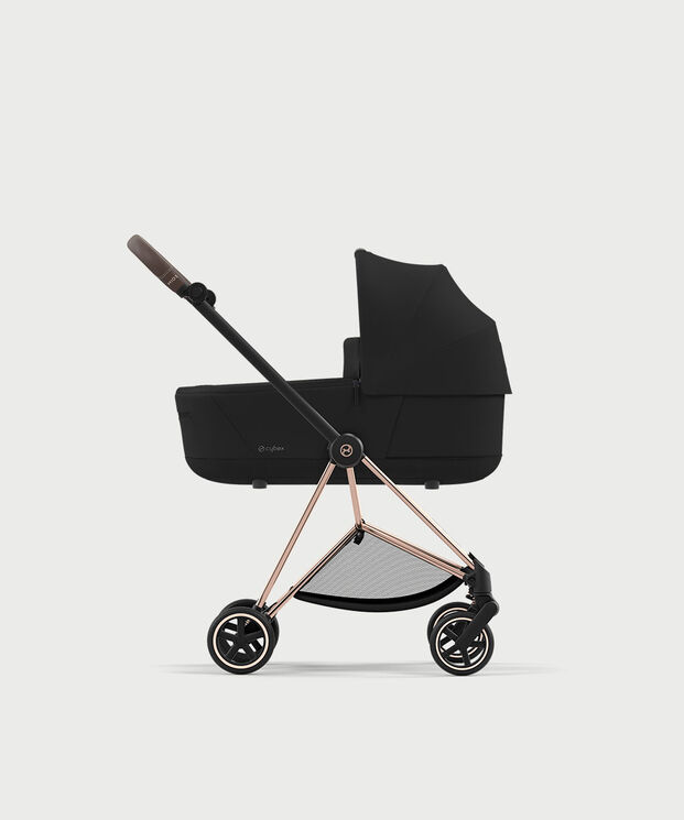 Black pram with brown handle on a white background.