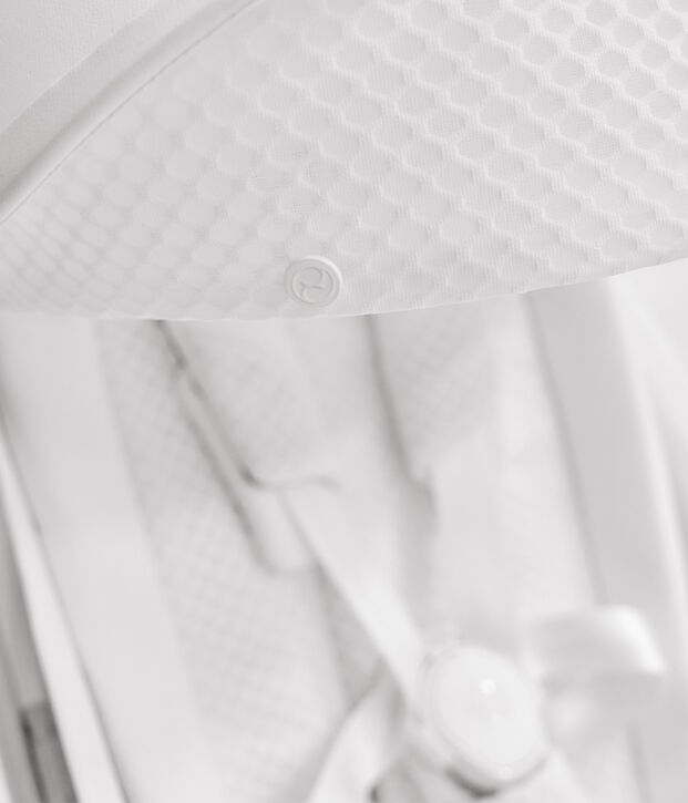 A white textured material with a small round button in the centre.
