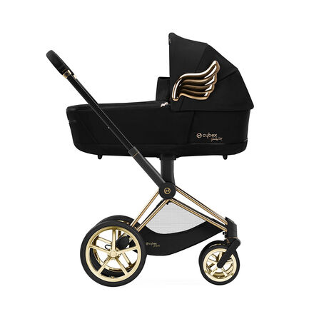 Cybex by Jeremy Scott Wings pram in black with gold accents and wing design on the side.