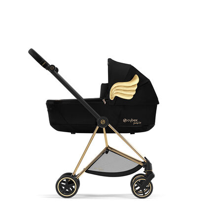 Cybex by Jeremy Scott Wings pram featuring gold wings on the side, black fabric, and gold details.