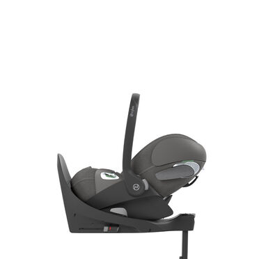 A grey Cybex baby car seat mounted sideways on a base.