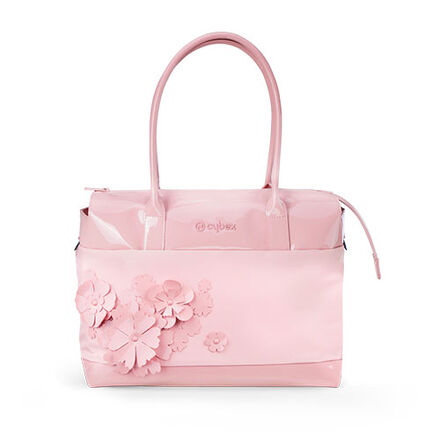 A light pink CYBEX Simply Flowers changing bag with pink 3D flower appliqu&eacute;s, front view, studio shot on a white backdrop.