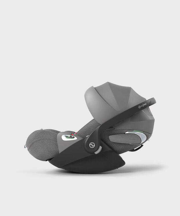 A grey baby car seat with a black frame and adjustable canopy.