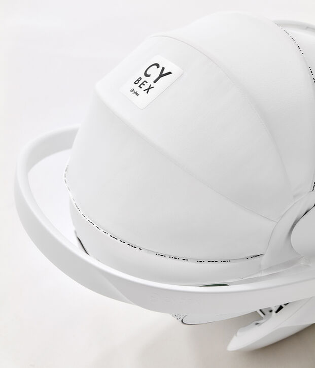 A white Cybex pram attachment with a clearly visible logo.