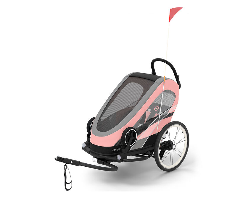 Pink Zeno Bike trailer for kids with a flag.
