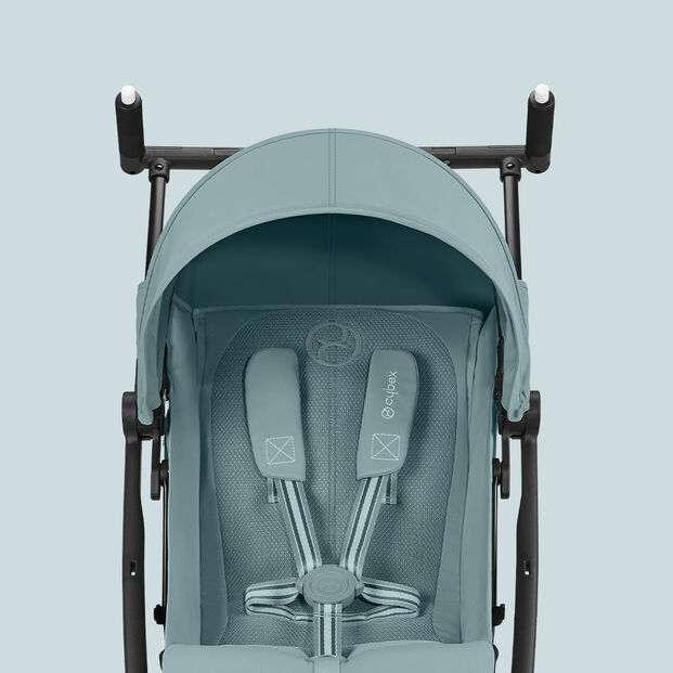 Turquoise Libelle stroller, smallest fold stroller, featuring padded seat and safety harness.