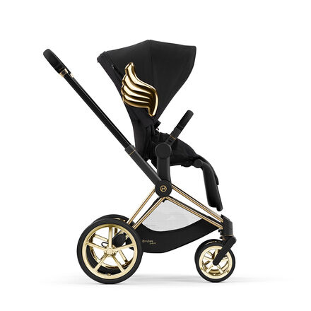 Black pram by Jeremy Scott Wings with gold accents and wings on the side.