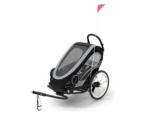 Zeno Bike trailer, a sleek black and grey bike trailer for kids with a red flag.