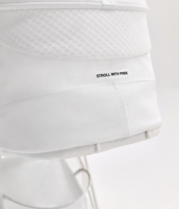 White fabric texture with the text "Stroll with Pride".