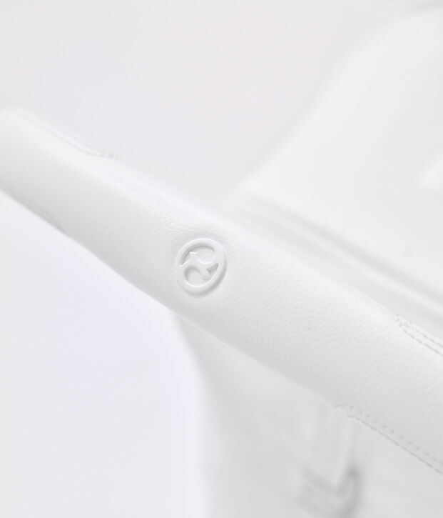 Close-up of a white, textured material with the brand's logo.