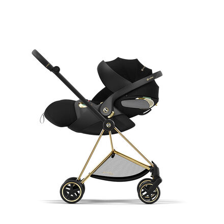 Black and gold stroller model by Jeremy Scott Wings with sleek details.