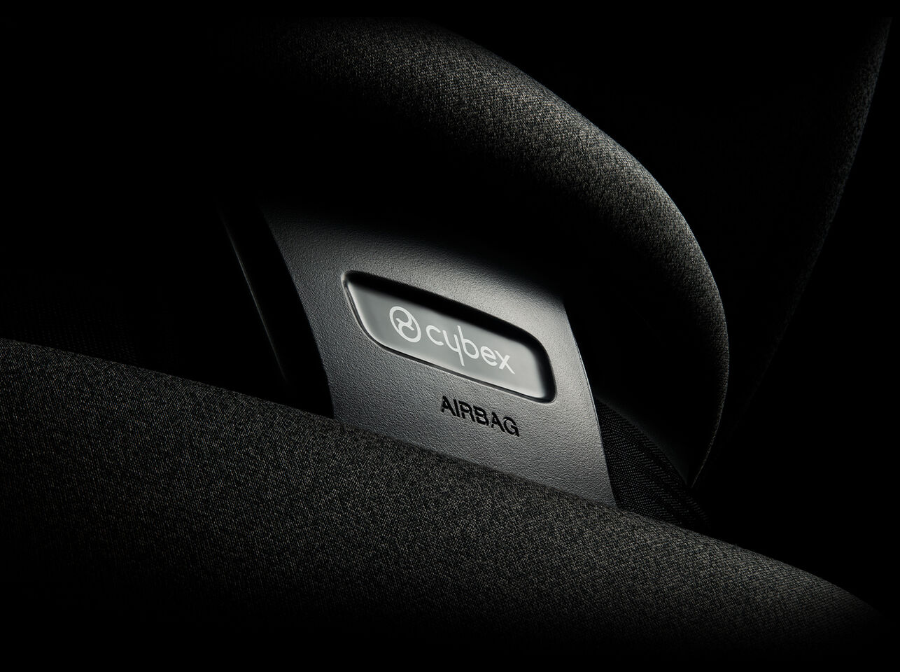 Cybex logo on a car seat with airbag label.