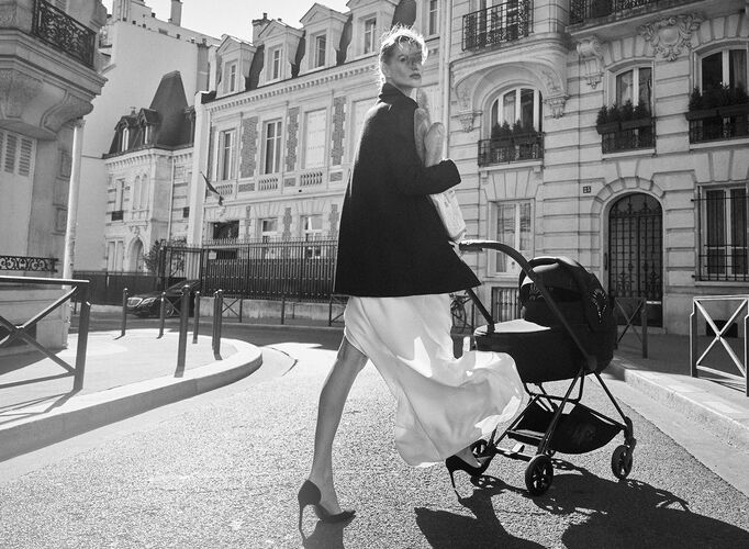 A woman strolling through the streets of Paris with her La Parisienne stroller