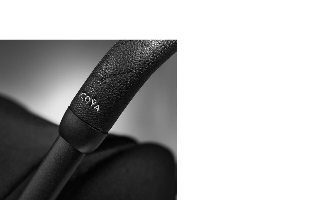 La Parisienne pushchair with black leather handle and "Coya" logo.
