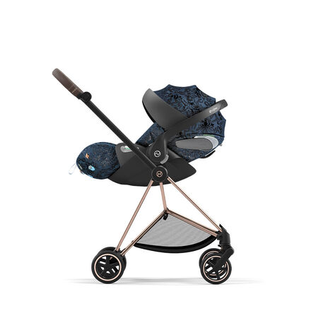 Stroller with blue pattern and black frame, side view.