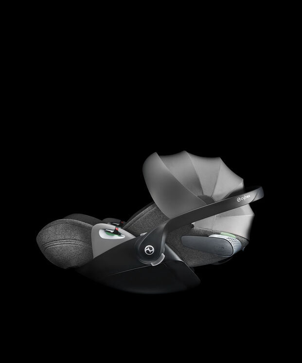 A grey Cybex car seat with adjustable sun canopy on a black background.