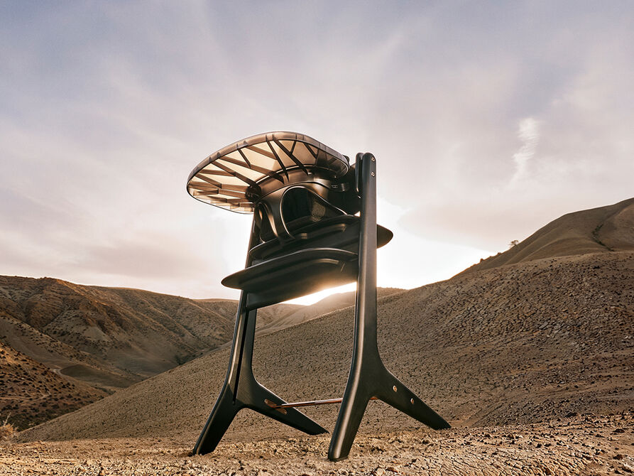 Lemo Platinum high chair in a desert landscape at sunset.