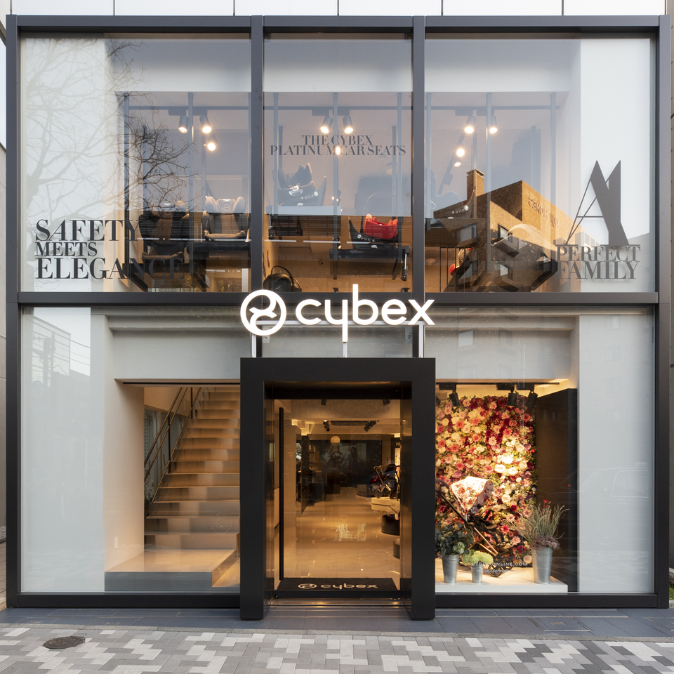 Storefront of Cybex with large windows displaying car seats and prams.