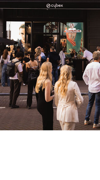 Multiple people standing in front of a CYBEX flagship store.