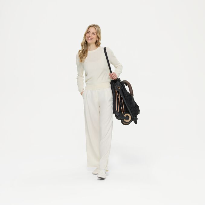 An image of the CYBEX Platinum Coya - Style Collection Buggy, highlighting the Integrated Carry Strap feature.